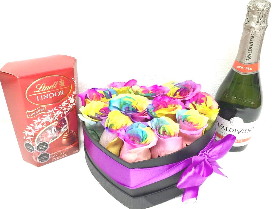 Caja Corazón con 12 Rosas Arcoíris, Bombones Lindor 200grs y Champagne 375cc